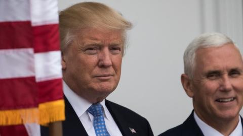 President-elect Donald Trump and vice president-elect Mike Pence listen to a question from the press regarding the musical 'Hamilton' before their meeting with investor Wilbur Ross at Trump International Golf Club, November 20, 2016 in Bedminster Township