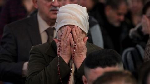 Iraqi Christians attend a Christmas mass at the Catholic Church of Our Lady of Deliverance/Salvation (Sayidat al-Nejat), in central Baghdad, on December 25, 2015. (AHMAD AL-RUBAYE/AFP/Getty Images)