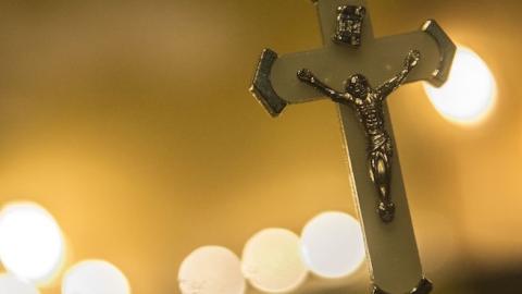 A crucifix is seen hanging as Egyptians attend a candle vigil on December 17, 2016 outside the Saint Peter and Saint Paul Coptic Orthodox Church in Cairo. (KHALED DESOUKI/AFP/Getty Images)