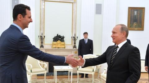 Russian President Vladimir Putin (R) greets his Syrian counterpart Bashar al-Assad (L) during a meeting at the Kremlin in Moscow on October 20, 2015. (ALEXEY DRUZHININ/AFP/Getty Images)