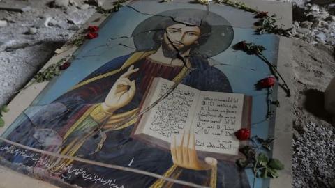 A damaged painting of Jesus Christ on the ground of Syriac Orthodox Um al-Zinar church in the Christian Hamidiyeh neighbourhood of the old city of Homs, central Syria, May 12, 2014. (JOSEPH EID/AFP/Getty Images)