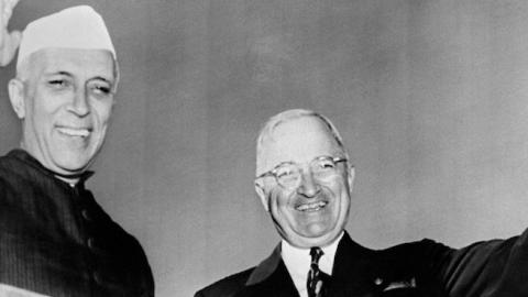 Indian prime minister Pandit Jawaharlal Nehru and US president Harry Truman wave to journalists upon the arrival on the Washington airport of the Indian Government chief, October 13, 1949. (STAFF/AFP/Getty Images)