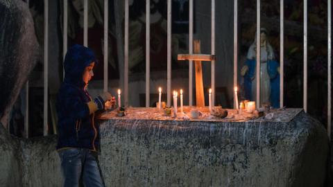 A Iraqi Christian boy lights candles inside a shrine in the grounds of Mazar Mar Eillia (Mar Elia) Catholic Church, on December 12, 2014 in Erbil, Iraq. (Matt Cardy/Getty Images)