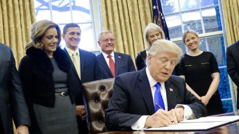 President Donald Trump signs three executive actions in the Oval Office on January 28, 2017 in Washington, DC. (Pete Marovich - Pool/Getty Images)