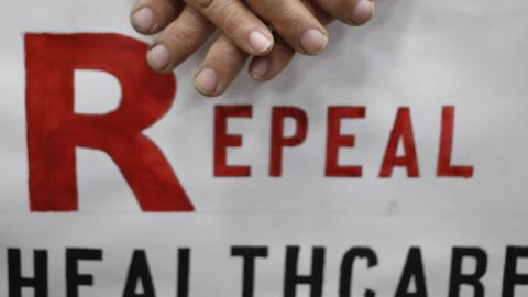 James Hughes of Louisville, Ky. holds a sign calling for the repeal of the Affordable Care Act during a rally for Mitch McConnell (R-KY) at Brandeis Machinery & Supply Company in Louisville, Kentucky, October 31, 2014. (Luke Sharrett/Getty Images)