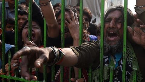 Pakistani devotees gather outside the shrine of 13th century Muslim Sufi saint Lal Shahbaz Qalandar a day after a bomb blew up at the shrine in the town of Sehwan in Sindh province, February 17, 2017. (ASIF HASSAN/AFP/Getty Images)