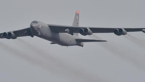 A US B-52 Stratofortress (R) is escorted by a South Korean F-15K fighter jet (L) as it flies over the Osan Air Base in Pyeongtaek, south of Seoul, on January 10, 2016. (JUNG YEON-JE/AFP/Getty Images)