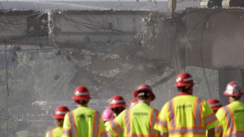 A group of people monitor construction crews demolishing a portion of the Mulholland Drive bridge along the 405 Freeway September 29, 2012 in Los Angeles, California. (Jonathan Alcorn/Getty Images)