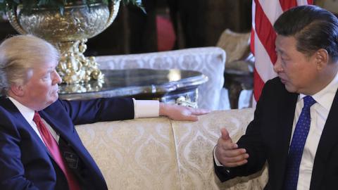 Chinese President Xi Jinping (R) meets with his U.S. counterpart Donald Trump in the latter's Florida resort of Mar-a-Lago in the United States, April 6, 2017. (Xinhua/Lan Hongguang via Getty Images)