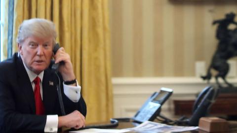 President Donald Trump is seen through a window speaking on the phone in the Oval Office of the White House, January 29, 2017 in Washington, DC. (Mark Wilson/Getty Images)