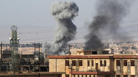 Smoke billows in a neighbourhood called 17 Tammuz following a car bomb explosion, west of Mosul, on May 18, 2017 (AHMAD AL-RUBAYE/AFP/Getty Images)