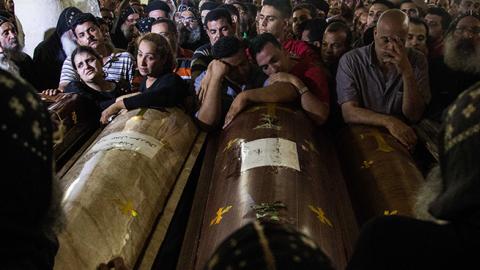 Relatives of Coptic Christians who were killed during a bus attack, surround their coffins, during their funeral service, at Ava Samuel desert monastery in Minya, Egypt, May 26, 2017 (Ibrahim Ezzat/NurPhoto via Getty Images)