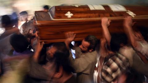 Relatives of killed Coptic Christians carry a coffin as they gather outside the Abu Garnous Cathedral in the north Minya town of Maghagha, on May 26, 2017 (MOHAMED EL-SHAHED/AFP/Getty Images)