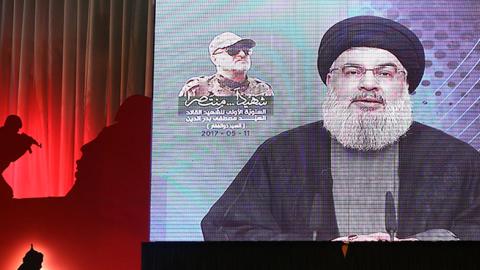 Secretary-General of Hezbollah Hassan Nasrallah live broadcasts during a commemoration event for Mustafa Badreddine, a soldier of Hezbollah killed in Syria, in Dahieh district of Beirut, Lebanon on May 11, 2017 (Ratib Al Safadi/Anadolu Agency/Getty Images