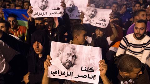 Demonstrators hold pictures of Nasser Zafzafi, leader of the Rif region's protest movement, during a demonstration against corruption, repression and unemployment in the northern city of al-Hoceima, Morocco, May 29, 2017 (FADEL SENNA/Getty Images)