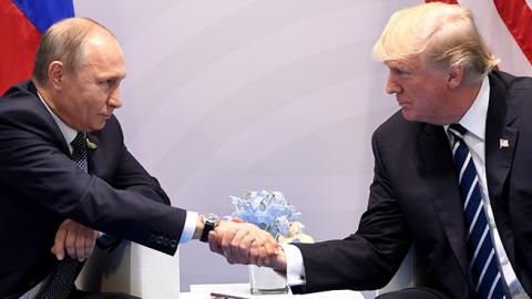 President Donald Trump and Russian President Vladimir Putin shake hands during a meeting on the sidelines of the G20 Summit in Hamburg, Germany, July 7, 2017 (SAUL LOEB/AFP/Getty Images)