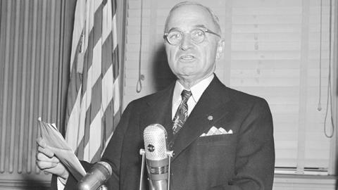 President Truman reading a statement warning that the U.S. is considering using the atomic bomb in the Korean War, November 30, 1950 (Bettmann Archives)
