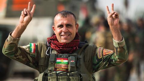 Peshmerga fighter flashes the V-sign after combat against Islamic State in Bashiqa, November 9, 2016 (ODD ANDERSEN/AFP/Getty Images)
