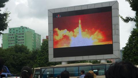 People watch as coverage of an ICBM missile test is displayed on a screen in a public square in Pyongyang, July 29, 2017 (KIM WON-JIN/AFP/Getty Images)