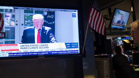 A television at the New York Stock Exchange shows President Trump announcing withdrawal from Paris Climate Accord, June 1, 2017 (BRYAN R. SMITH/AFP/Getty Images)