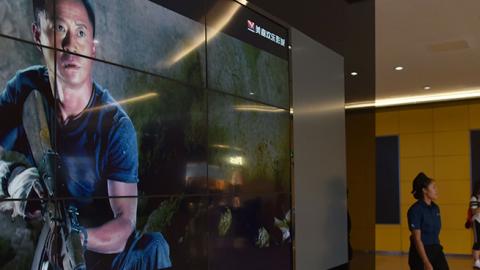 Screen at Beijing movie theater showing scenes from Wolf Warrior II, August 21, 2017 (GREG BAKER/AFP/Getty Images)
