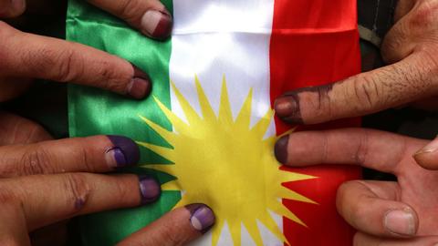 Members of a Kurdish Peshmerga battalion show their ink-stained fingers after voting in the Kurdish independence referendum, September 25, 2017 (SAFIN HAMED/AFP/Getty Images)