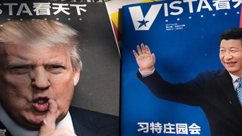 Magazines featuring front pages of US President Donald Trump and China's President Xi Jinping displayed at a news stand in Beijing, April 6, 2017 (NICOLAS ASFOURI/AFP/Getty Images)