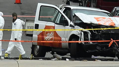 Investigators work around the wreckage of a Home Depot pickup truck a day after it was used in a terror attack in New York, November 1, 2017 (JEWEL SAMAD/AFP/Getty Images)