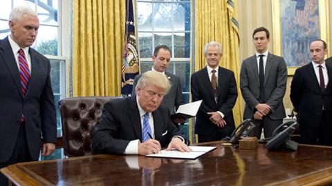 President Trump signing Executive Orders, January 23, 2017 (Ron Sachs - Pool/Getty Images)