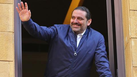 Former Lebanese prime minister Saad Hariri greets his supporters upon his arrival at his home in Beirut on November 22, 2017 (STR/AFP/Getty Images)
