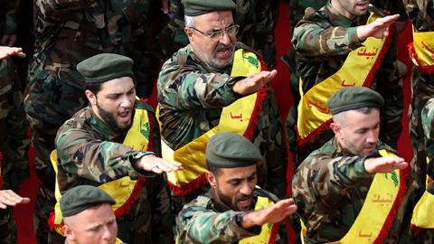 Hezbollah fighters salute during funeral for comrades killed in Syria, November 8, 2017 (MAHMOUD ZAYYAT/AFP/Getty Images)