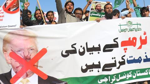 Protesters hold anti-Trump signs after his statement on Pakistan, January 2, 2018 (Sabir Mazhar/Anadolu Agency/Getty Images)