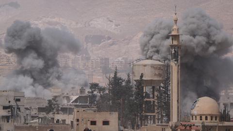 Smokes rise after Assad Regime forces carried out airstrikes in Eastern Ghouta, April 7, 2018 (Halil el-Abdullah/Anadolu Agency/Getty Images)