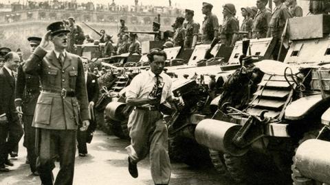 Charles de Gaulle salutes Free French tanks and their crews after the liberation of Paris, August 1944 (Rykoff Collection/Getty Images)