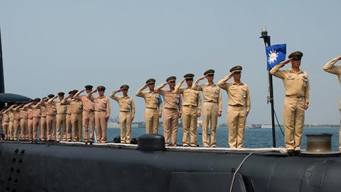 Taiwanese navy staffs salute from a US-made Guppy class submarine at the Tsoying navy base in southern Kaohsiung, September 30, 2014 (SAM YEH/AFP/Getty Images)