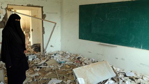 Yemeni member of a school administration inspects the damage on the first day of the new academic year, September 16, 2018 (AHMAD AL-BASHA/AFP/Getty Images)