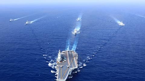 A PLA Navy fleet including the aircraft carrier Liaoning, vessels and fighter jets take part in a drill in April 2018 in the South China Sea. (Photo by VCG)