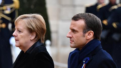 President Emmanuel Macron and German Chancellor Angela Merkel arrive at the Elysee Palace after the ceremony for the Centenary of the World War I Armistice in Paris, France on November 11, 2018. (Mustafa Yalcin/Anadolu Agency/Getty Images)