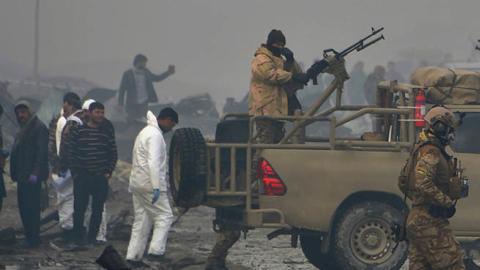 Afghan security forces and investigators gather at the site of a suicide bomb attack outside a British security firm's compound in Kabul on November 30, 2018. At least 10 people were killed. (NOORULLAH SHIRZADA/AFP/Getty Images)