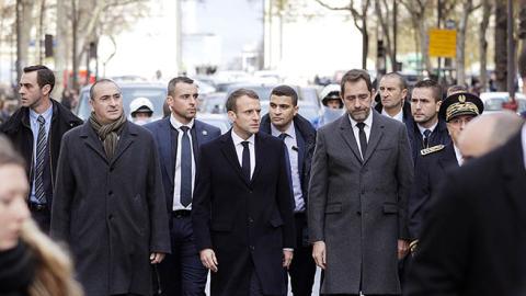 French President Emmanuel Macron walks a street of Paris on December 2, 2018, a day after clashes during a protest of Yellow vests (Gilets jaunes) against rising oil prices and living costs. (Photo credit: GEOFFROY VAN DER HASSELT/AFP/Getty Images)