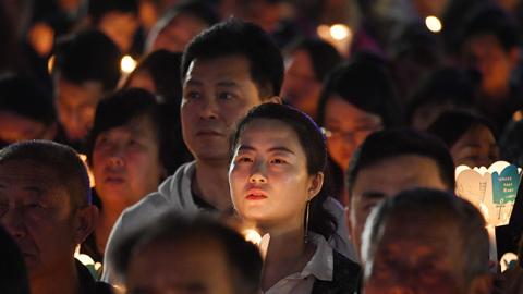 Catholic worshippers attend a mass on Holy Saturday, part of Easter celebrations at Beijing's government sanctioned South Cathedral on March 31, 2018. (Photo credit: GREG BAKER/AFP/Getty Images)