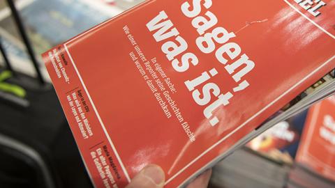 A man holts the latest issue of German newsweekly Der Spiegel with a cover page that reads: 'To say, what is' at a kiosk on December 22, 2018 in Cologne, Germany. (Photo by Thomas Lohnes/Getty Images)