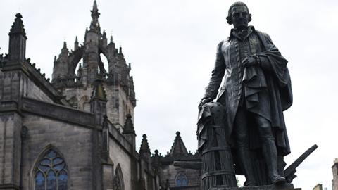 A statue of Scottish economist Adam Smith stands on the Royal Mile in Edinburgh, Scotland. (OLI SCARFF/AFP/Getty Images)