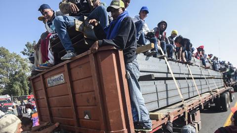 Central American migrants taking part in a caravan to the U.S., are pictured on board a truck heading to Irapuato in the state of Guanajuato on November 11, 2018 after spending the night in Queretaro in central Mexico. (ALFREDO ESTRELLA/AFP/Getty Images)