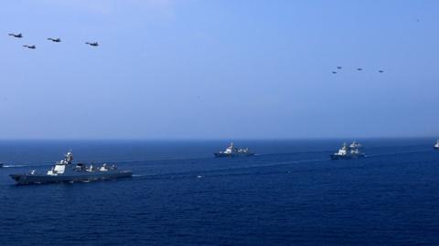 A PLA Navy fleet including the aircraft carrier Liaoning, submarines, vessels and fighter jets take part in a review in the South China Sea on April 12, 2018 in At Sea, China. (VCG via Getty Images)