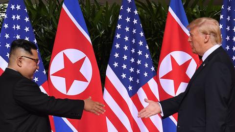 North Korea's leader Kim Jong Un shakes hands with U.S. President Donald Trump at the start of their historic U.S.-North Korea summit, at the Capella Hotel on Sentosa island in Singapore on June 12, 2018. (SAUL LOEB/AFP/Getty Images)