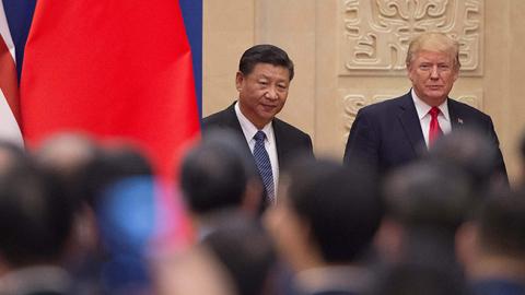 U.S. President Donald Trump and China's President Xi Jinping arrive at a business leaders event inside the Great Hall of the People in Beijing on November 9, 2017.  (NICOLAS ASFOURI/AFP/Getty Images)