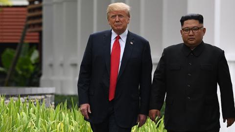 North Korea's leader Kim Jong Un walks with U.S. President Donald Trump during a break in talks at their historic US-North Korea summit, in Singapore on June 12, 2018. (SAUL LOEB/AFP/Getty Images)
