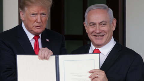 President Donald Trump and Prime Minister of Israel Benjamin Netanyahu (R) show members of the media the proclamation recognizing Israel’s sovereignty over Golan Heights on March 25, 2019 in Washington, DC. (Alex Wong/Getty Images)