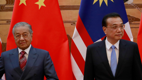 Malaysian Prime Minister Mahathir Mohamad and his Chinese counterpart Li Keqiang arrive for a signing ceremony at the Great Hall of the People in Beijing, China, August 2018. (Pool/Getty Images)